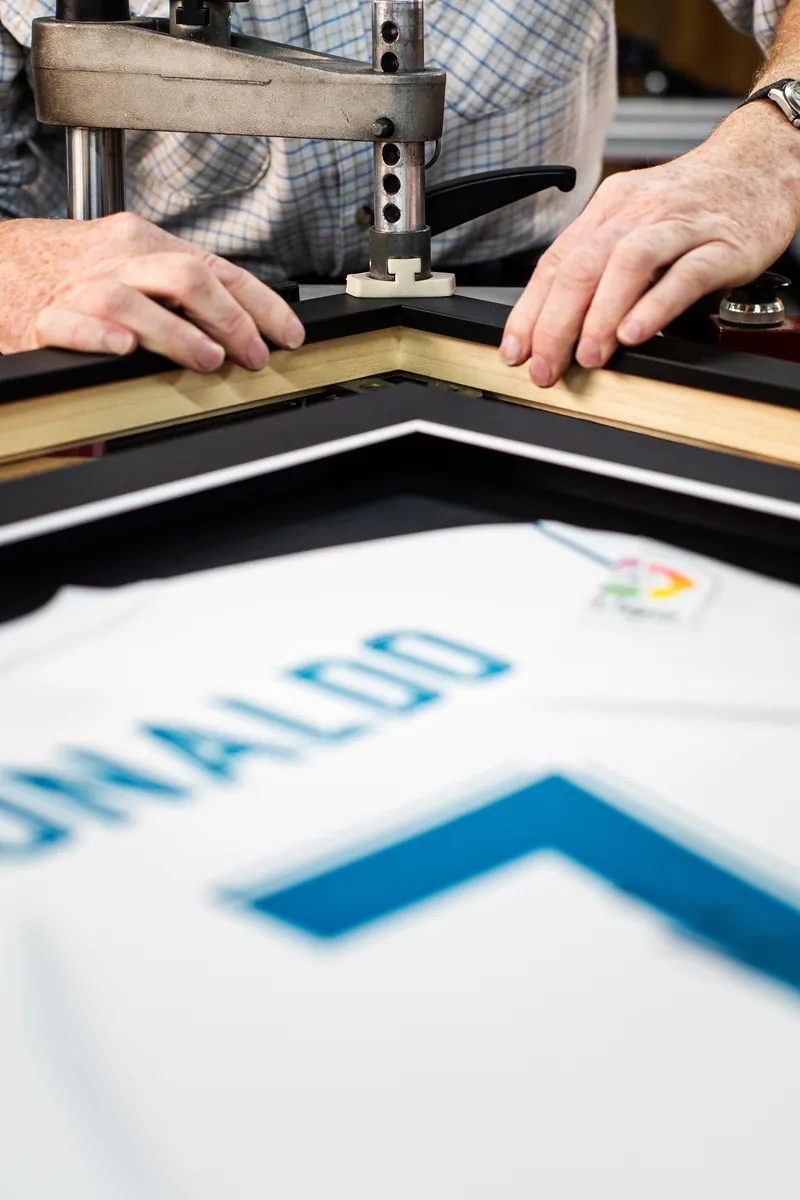Joining the corners of a solid wood frame, with a Ronaldo shirt ready to go in